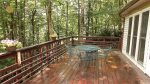 Furnished back deck in peaceful wooded setting